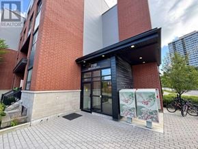 Toronto (L'amoreaux) townhouse for rent - A red brick building with a black awning and a glass door entrance.