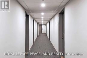 Toronto (L'amoreaux) townhouse for rent - A long hallway with doors on both sides and a logo on the wall.