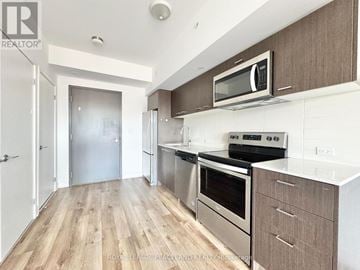 Toronto (L'amoreaux) townhouse for rent - A kitchen with a stainless steel oven and microwave.