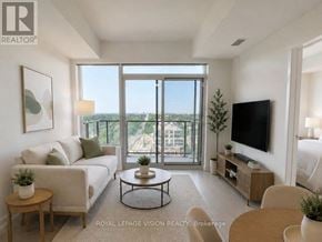 Toronto (Humber Heights) condo for rent - A living room with a couch, a coffee table, a television, and a large window overlooking a cityscape.