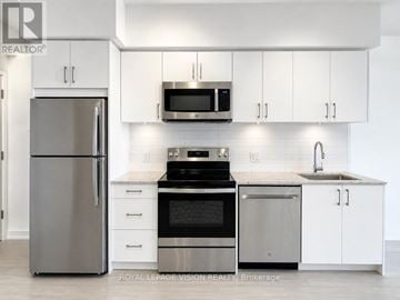 Toronto (Humber Heights) condo for rent - A modern kitchen with white cabinets and stainless steel appliances.