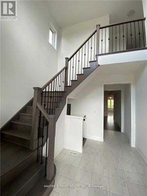 East Gwillimbury (Holland Landing) apartment for rent - A staircase with a railing and a white door at the bottom.