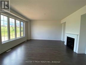 East Gwillimbury (Holland Landing) apartment for rent - A large, empty room with a fireplace and a view of the outdoors through the windows.