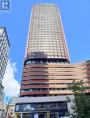 Toronto (Moss Park) condo for rent - A tall building with a sign that says "REALTOR" on it.