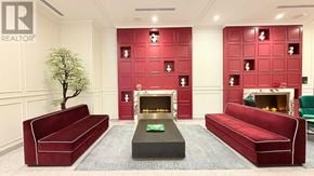 Toronto (Moss Park) condo for rent - A living room with red couches and a fireplace.