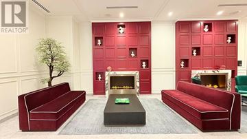 Toronto (Moss Park) condo for rent - A living room with red couches and a fireplace.