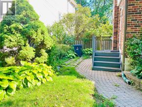 Toronto (Willowdale East) apartment for rent - A green bush is in front of a house.