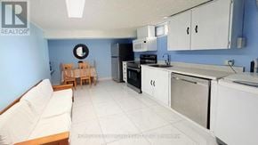 Richmond Hill (Crosby) apartment for rent - A kitchen with white appliances and a blue wall.