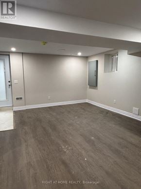 Halton Hills (Georgetown) apartment for rent - A room with wood flooring and white walls.