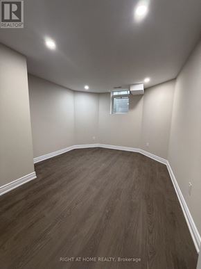 Halton Hills (Georgetown) apartment for rent - A room with wooden flooring and white walls.