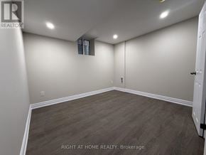 Halton Hills (Georgetown) apartment for rent - A room with wood flooring and white walls, with a door on the right side.