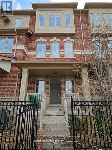 Brampton (Heart Lake East) townhouse for rent - A brick house with a black iron fence in front.