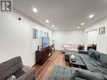 Brampton (Madoc) apartment for rent - A living room with a grey couch and a television on a wooden cabinet.