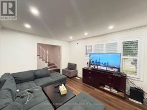 Brampton (Madoc) apartment for rent - A living room with a grey sofa and a television on a wooden stand.