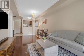 Mississauga (Churchill Meadows) condo for rent - A living room with a grey couch and a coffee table.
