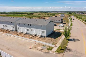 Sylvan Lake apartment for rent - A construction site with a building under construction and a road in front.