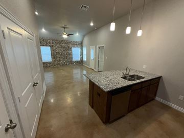Temple townhouse for rent - A kitchen area with a stone wall and a sink.