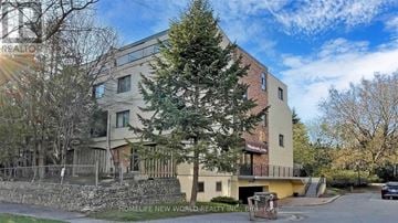 Toronto (Hillcrest Village) townhouse for rent - A building with the sign "HOMELIFE NEW WORLD REALTY INC." in front of it.