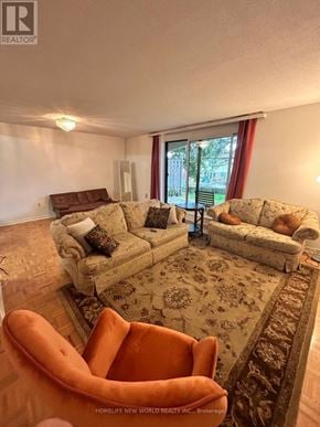 Toronto (Hillcrest Village) townhouse for rent - A living room with a couch, chair, and rug.