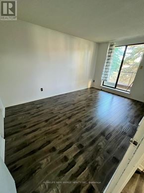 Toronto (Hillcrest Village) townhouse for rent - A room with wooden flooring and a window with a view of trees.