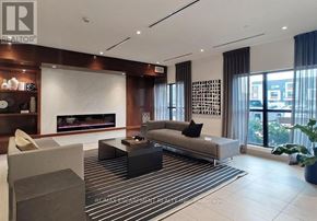 Oakville (Go Glenorchy) condo for rent - A modern living room with a fireplace and a striped rug.