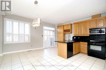 Mississauga (Applewood) apartment for rent - A well-lit kitchen with wooden cabinets and black appliances.
