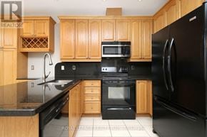 Mississauga (Applewood) apartment for rent - A kitchen with wooden cabinets and black appliances.