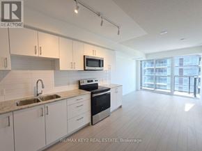 Toronto (Humber Heights) condo for rent - A kitchen with white cabinets and appliances in a modern style.