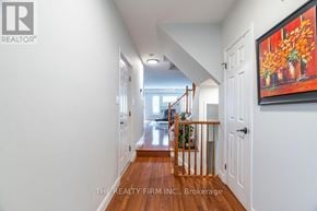 London North (North A) townhouse for rent - A hallway with a painting on the wall and a door on the right.