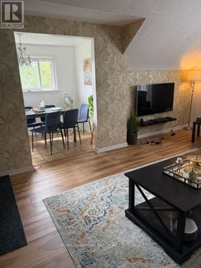 Richmond Hill (Mill Pond) apartment for rent - A living room with a television, a dining table with chairs, and a rug.
