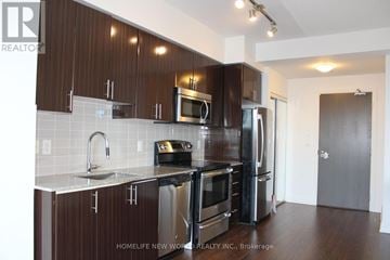 Markham (Thornhill) condo for rent - A kitchen with dark wood cabinets and stainless steel appliances.