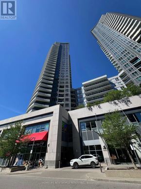 Markham (Thornhill) condo for rent - A white car is parked in front of a building with a red awning.