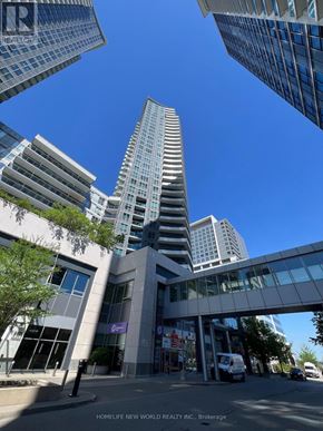 Markham (Thornhill) condo for rent - A tall building with a glass facade stands in front of a HomeLife New World Realty Inc. office.