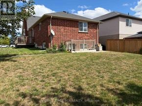 Orangeville apartment for rent - A red brick house with a white satellite dish on the roof.