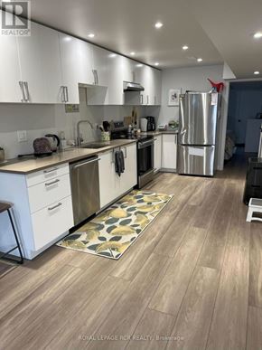 Orangeville apartment for rent - A kitchen with white cabinets and a wooden floor.