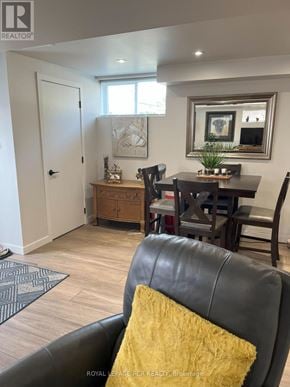 Orangeville apartment for rent - A living room with a black leather couch and a wooden table.