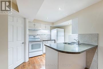 Milton (Be Beaty) apartment for rent - A kitchen with white cabinets and a countertop with a sink.