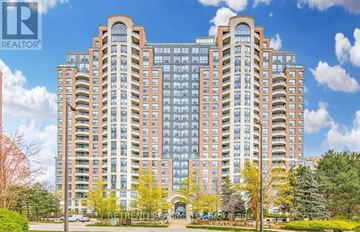 Toronto (Willowdale West) condo for rent - A large, modern building with a glass facade and a sign that reads "RETAIL".