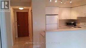 Toronto (Willowdale West) condo for rent - A kitchen with white cabinets and a refrigerator.