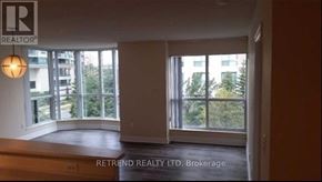 Toronto (Willowdale West) condo for rent - A room with a large window and a balcony overlooking a building.