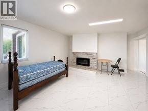 Richmond apartment for rent - A bedroom with a bed, a table and a chair.
