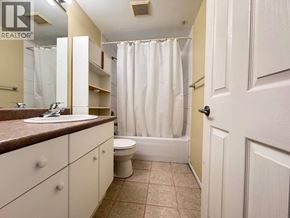 Vancouver apartment for rent - A bathroom with a sink, toilet, and bathtub.