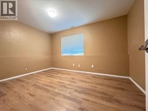 Vancouver apartment for rent - A room with wooden flooring and a window overlooking the beach.