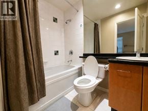 Vancouver townhouse for rent - A bathroom with a toilet, sink, and bathtub.