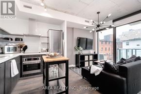 Toronto (Waterfront Communities) condo for rent - A modern kitchen with a dining table and a couch.