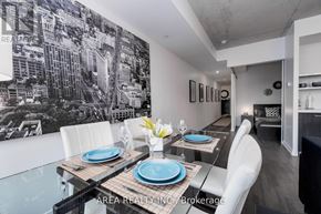 Toronto (Waterfront Communities) condo for rent - A dining room with a table set for two and a cityscape mural on the wall.