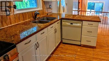 Markham (Royal Orchard) apartment for rent - A kitchen with white cabinets and a granite countertop.