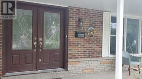 Markham (Royal Orchard) apartment for rent - A brown double door with glass panels is the main focus of the image.