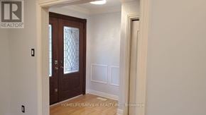 Markham (Royal Orchard) apartment for rent - A room with a wooden door and a window.