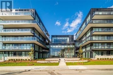Burlington (Lasalle) condo for rent - A modern building with glass windows and a clear blue sky in the background.